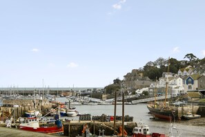 A harbor with boats docked, a bridge, and buildings in the background. - La Petite Maison is a dog-friendly waterfront dual-apartment in Brixham (Brixham)