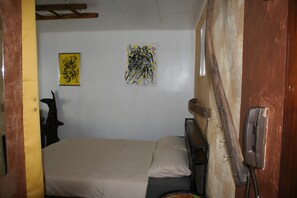A hotel room with a bed, a telephone, and two artworks on the wall. - Apartment for 2 Guests (39 m²) in Ludwigswinkel (Dogs Welcome) (Ludwigswinkel)