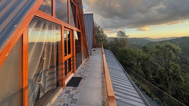 A modern building with large windows and a view of the surrounding landscape. - The Woodshed (Mukteshwar)