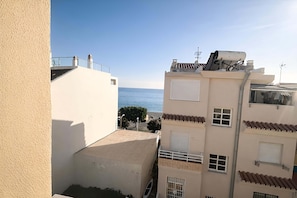 A residential building with a view of the sea, balconies, and a satellite dish. - Aire de Mar Apartment (Caleta de Vélez)