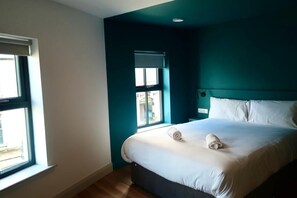 A hotel room with a bed, a window, and a door. - Heyday Hostel (Ballina)