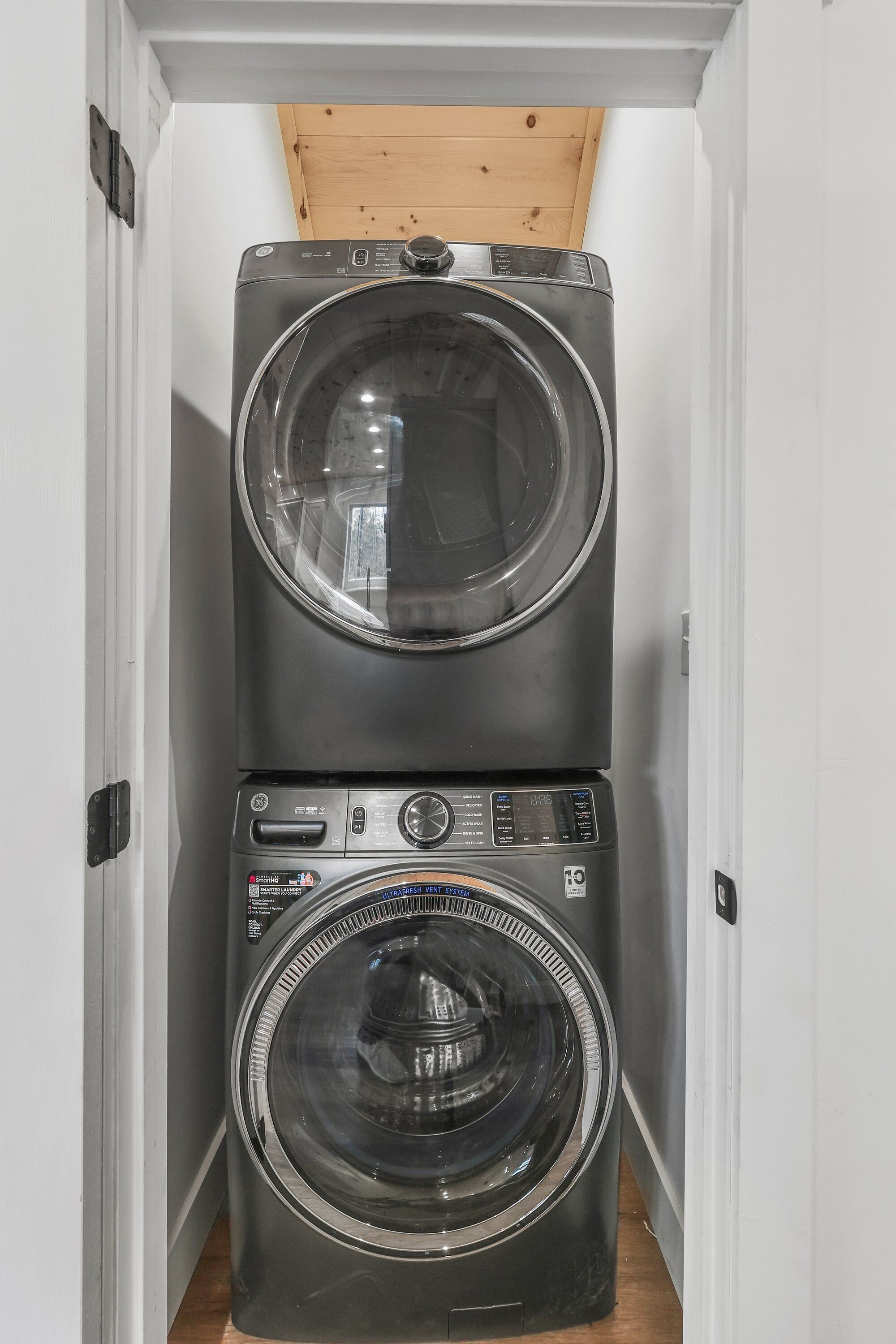 A laundry room with two stacked front-loading washing machines.
