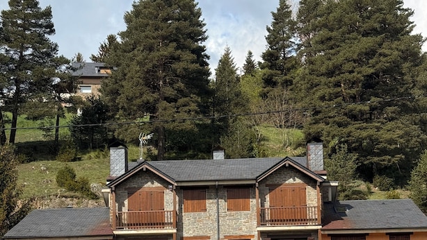 A two-story building with a stone facade, wooden shutters, and balconies. - 120 La Molina · Panoramic Views 5 Minutes From La Molina Ski Resort (Alp)
