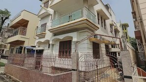 A multi-story residential building with balconies, a gated entrance, and a clear sky. - Kiya Kedia Niketan Salt Lake (Barasat)