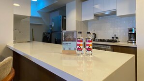 A modern kitchen with a central island, stainless steel appliances, and a coffee maker. - w Luxury 3BR w Balcony in Upscale Miraflores (Lima)