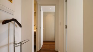 A hallway with a metal handrail, a door leading to a room, and a wooden floor. - w Luxury Cozy 2BR w Balcony in Miraflores (Lima)