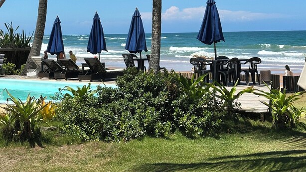 A beachside resort with lounge chairs, umbrellas, and a pool. - Beachfront Apartment on the Upper Floor: Best Value for Money (Maraú)