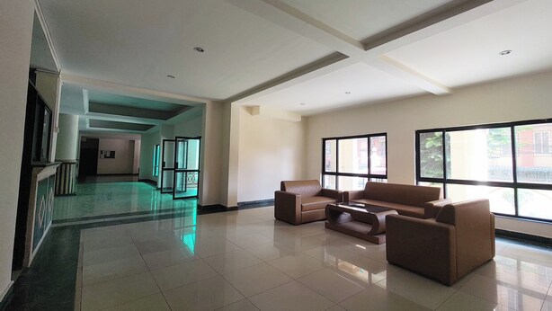 A spacious lobby with a high ceiling, large windows, and a central seating area. - Metro axis residency (Kathmandu)
