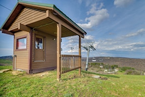 A small wooden cabin with a porch, a window, and a door. - Seven Springs Escape! 2 Connected Ski-in/out Units (Champion)