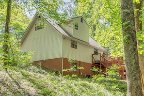 A two-story building with a wooden staircase leading to a balcony. - Game Room! Family Escape on Tims Ford Lake (Winchester)