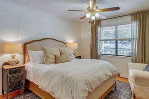 A bedroom with a bed, nightstands, a ceiling fan, and a window with curtains. - Game Room! Family Escape on Tims Ford Lake (Winchester)