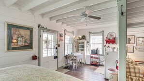 A room with a bed, a desk, a chair, a ceiling fan, and a window. - Walk to Wineries: Charming Retreat in Augusta! (Augusta)