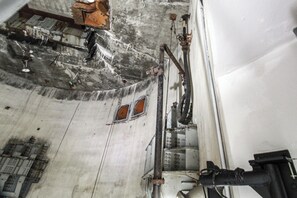 A room with a large window, a bed, and a wooden headboard. - Nuclear Missile Silo Bunker on Schilling Afb! (Brookville)