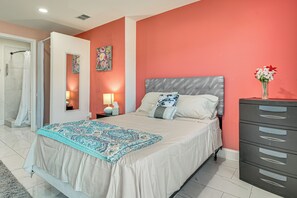 A bedroom with a bed, a nightstand, a dresser, a shower, and a door. - Explore Atl! Cozy Couple's Hideaway in Ellenwood (Ellenwood)