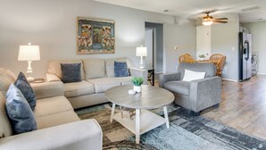A living room with a sofa, armchairs, a coffee table, and a dining area with chairs and a table. - 3 Mi to Branson Strip: 2-unit Gem w/ Pool Access! (Branson)