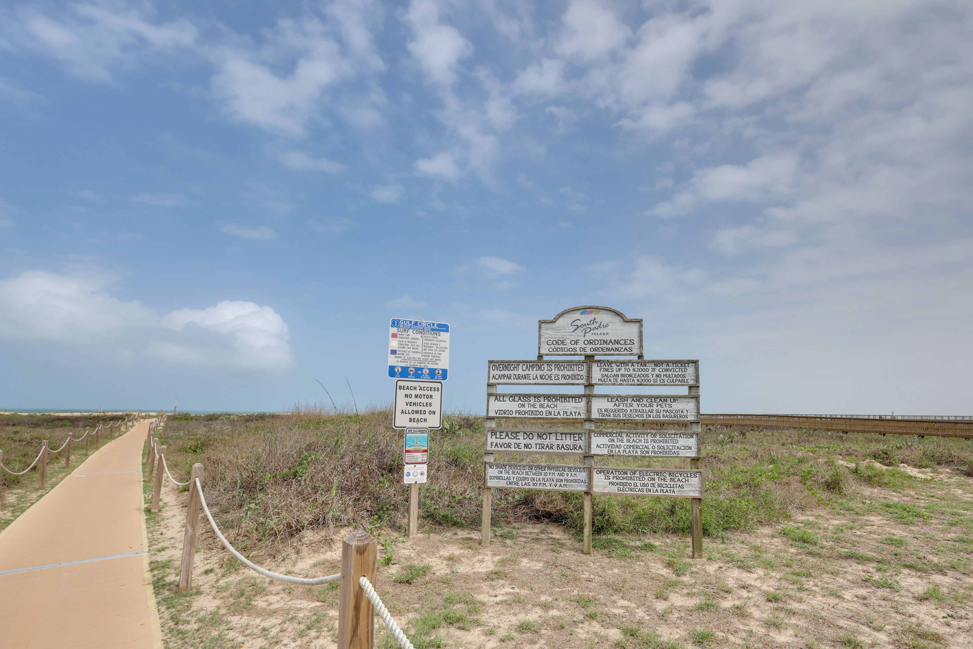 A beach access sign with multiple prohibitions and instructions.