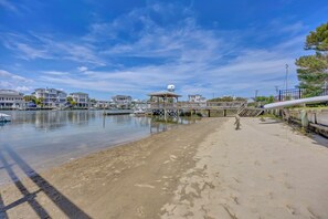 A waterfront property with a dock, a gazebo, and a beach. - The Dolphin House - 4 bedroom soundfront cottage (Wrightsville Beach)