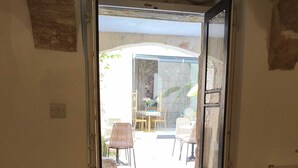 A room with a door leading to an outdoor patio area. - Wonderful Maltese Character 1-bedroom with AC in charming Ħal Tarxien (Ħal Tarxien)