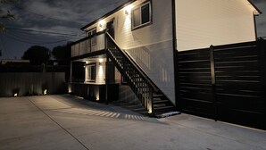 A two-story house with a balcony, a staircase, and a gated driveway. - Brand New next to Balboa Park, near Little Italy (San Diego)