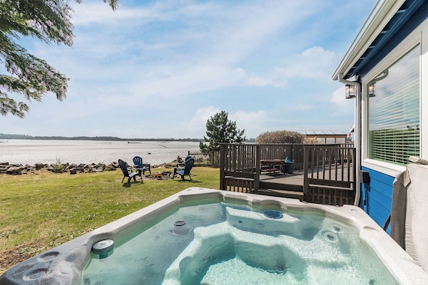Soak in your private hot tub while gazing at the pristine beach just steps from your door.