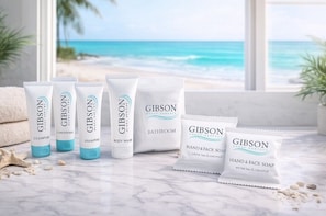 GIBSON Pflegeprodukte auf einer Marmorplatte mit Blick auf den Strand.