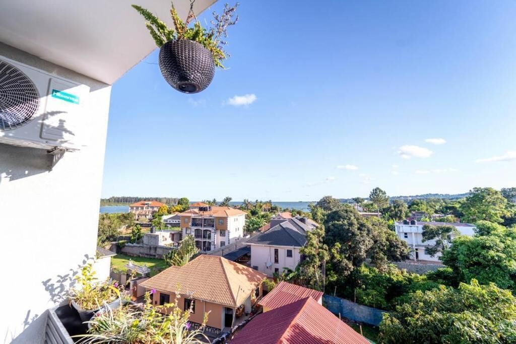 A residential area with houses, a clear sky, and hanging planters.