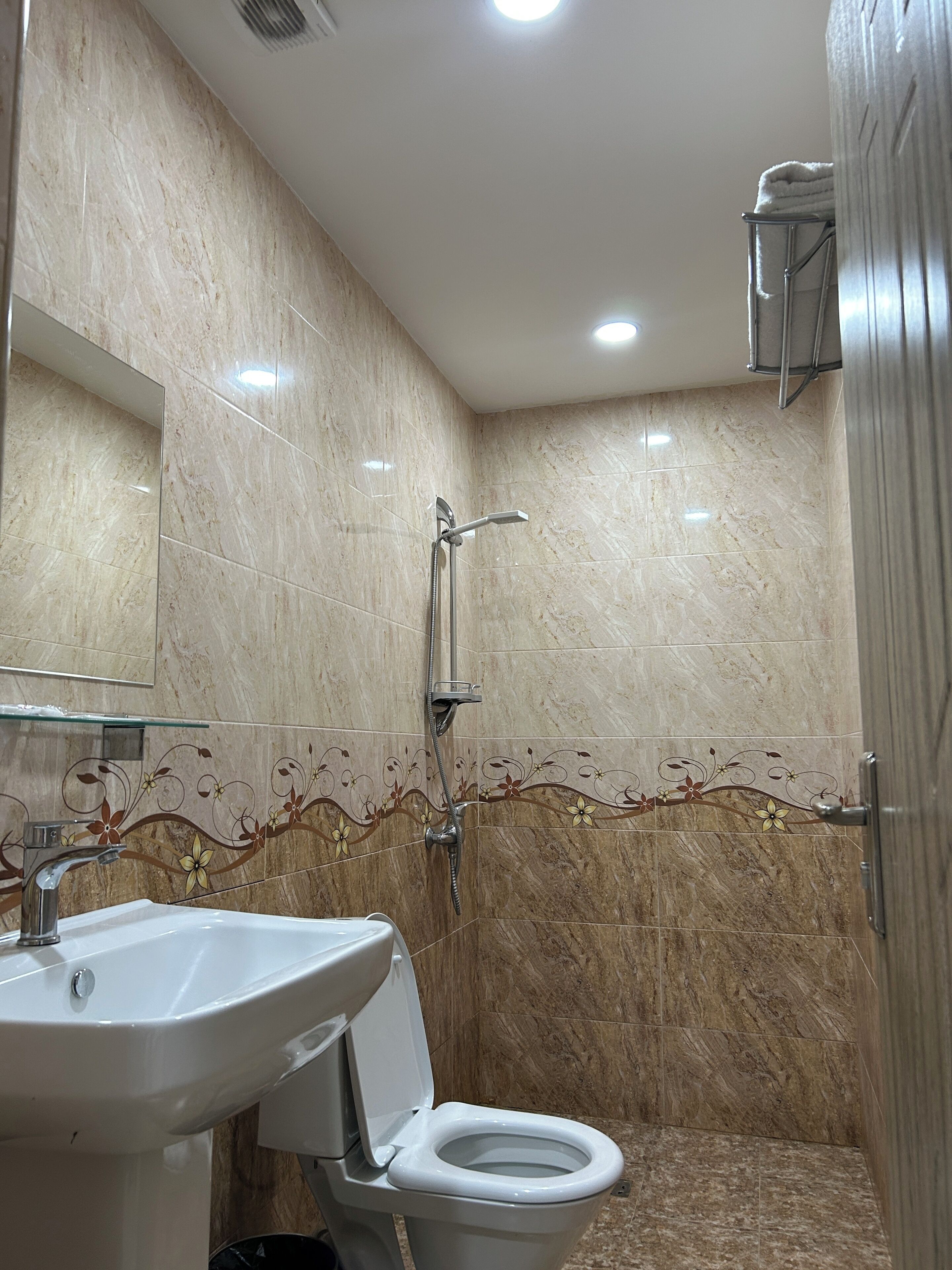 Ein Badezimmer mit Waschbecken, Toilette, Dusche und Spiegel.