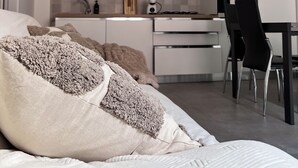 A modern bedroom with a bed, pillows, and a bedside table. - Heart Of Eagle - Dwelling in the historic center with private courtyard (L'Aquila)