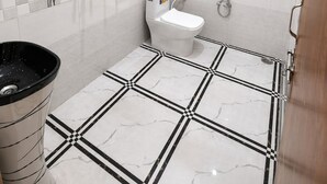 A bathroom with a toilet, bidet, and shower.