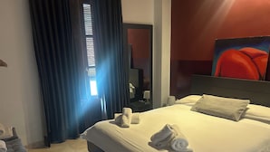 A hotel room with a bed, a desk, a chair, a window with curtains, a painting on the wall, and a mirror. - Spectacular penthouse with private terrace well communicated in the center of Granada (Granad)