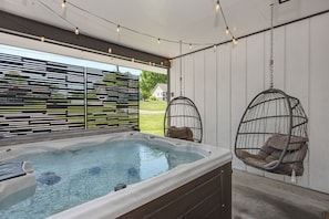 A hot tub with a view of a house, a hanging chair, and a string of lights. - Convenient 3BD w/ Hot Tub | Huge Yard + Near TOWN! (Sevierville)