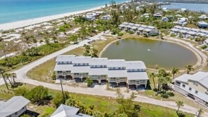 A coastal resort with beachfront villas, a central pool, and a road leading to the beach. - Welcome to your slice of paradise on Little Gasparilla Island (Placida, Little Gasparilla Island)