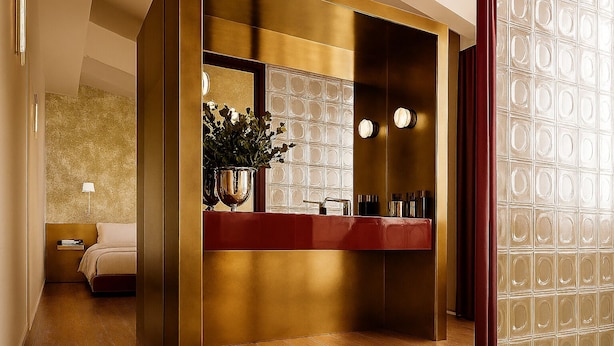 A hotel room with a modern design, featuring a large mirror, a red vanity, and a wooden floor. - Barberini 16 Boutique Hotel (Rome)