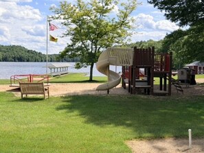 A playground with a slide and climbing structures near a lake. - Barnside Bungalow in peaceful Laporte, PA. (Muncy Valley)
