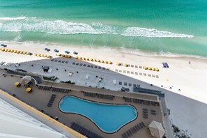 A resort with a pool, beach area, and sun loungers. - Luxury Beachfront 2BR Sleeps 8 Pool Amazing Views (Panama City Beach)