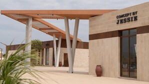A building with a modern architectural design, featuring a prominent sign that reads 'CONCEPT BY JESSIE.' - Good Days Habitat Soma Bay (Soma Bay)