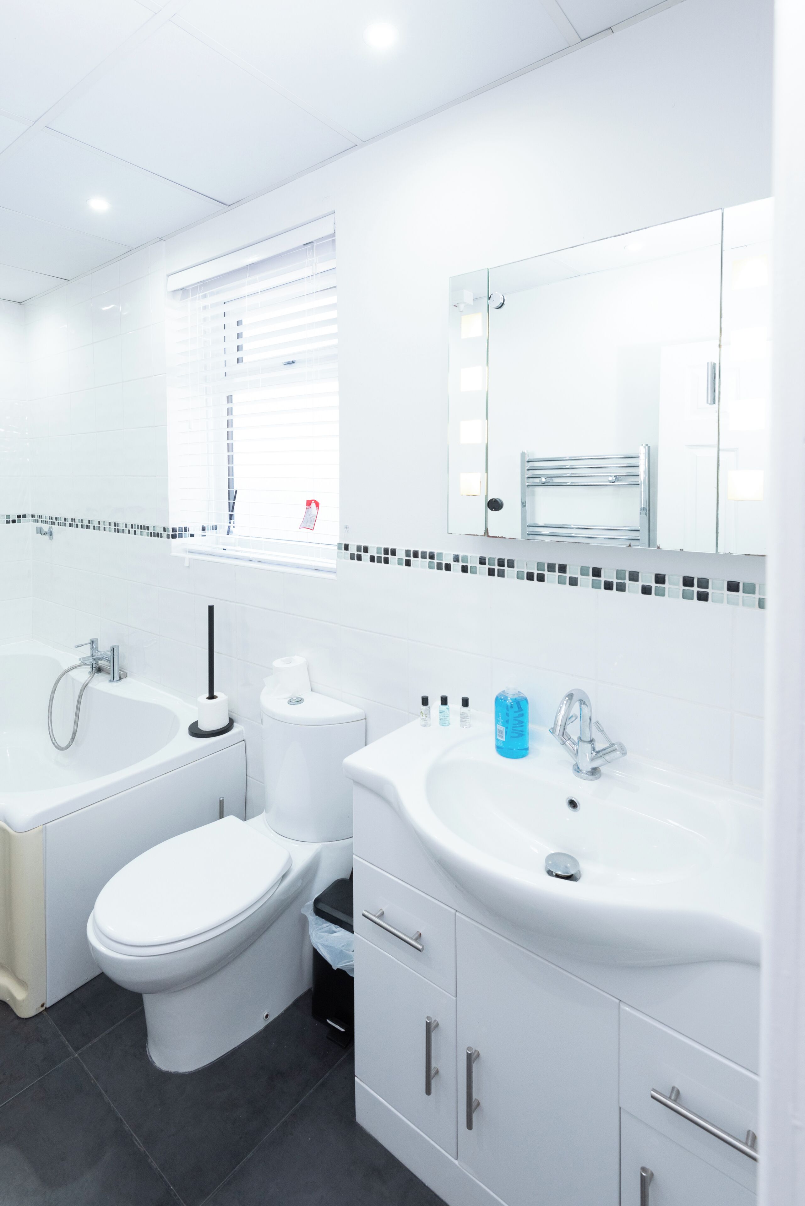 A modern bathroom with a toilet, sink, and bathtub.