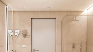 A modern bathroom with a toilet, sink, and shower.
