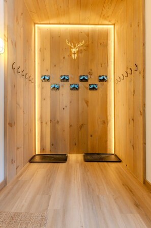 A wooden sauna with a deer head decoration, multiple sauna benches, and a wooden floor. - Stratton; walk on/off, shuttle Rt, pool table, shuffle puck, darts, dogs OK (Winhall)