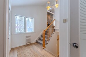 A staircase with wooden railings and a stone wall, leading to an upper floor. - Stratton; walk on/off, shuttle Rt, pool table, shuffle puck, darts, dogs OK (Winhall)