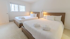 A hotel room with two beds, a large window, and a door. - Stratton; walk on/off, shuttle Rt, pool table, shuffle puck, darts, dogs OK (Winhall)