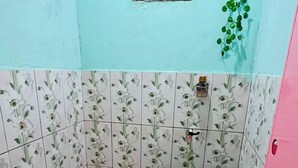 A small bathroom with a toilet, a trash bin, and a small window. - Bintang Sawarna 2 By ARBA (Bayah)