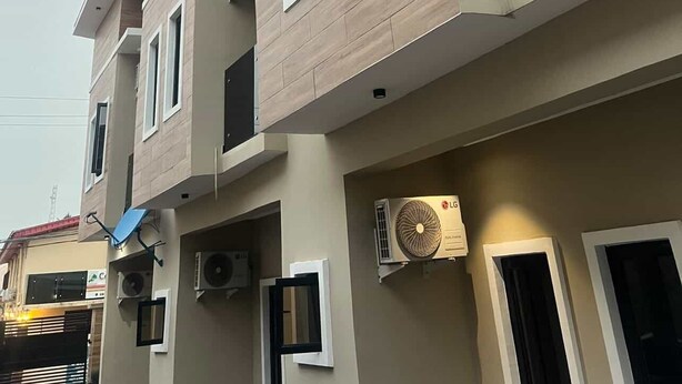A multi-story residential building with balconies, air conditioning units, and a flat roof design. - JOYZY HAVEN LUXURY SERVICE APARTMENT  (Ibadan)