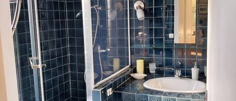 Shower, hair dryer, soap, toilet paper
