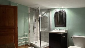 Ein Badezimmer mit Dusche, Waschbecken und Toilette.