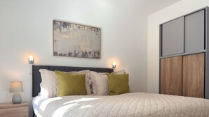 A bedroom with a bed, bedside table, wall-mounted light, and a painting. - St Johns Courtyard Suite, Bridgnorth with free private parking (Bridgnorth)