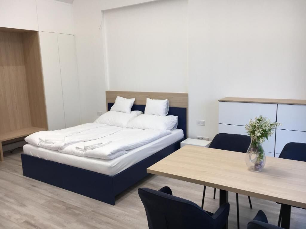 Une chambre d’hôtel moderne, équipée d’un lit, d’un bureau et d’une chaise.