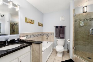 A bathroom with a bathtub, toilet, and shower. - Gated beachfront 3BR condo with stunning views, 2 pools & tennis court! (South Padre Island)