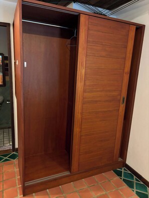 A wooden wardrobe with a sliding door, a metal handle, and a tiled floor. - Room-charming Apartment With Private Roo (Chiang Mai)