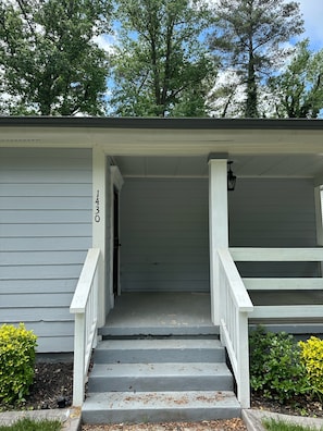 A house with a porch, a door, and a staircase leading to the entrance. -  4-BR, 3 bath in Atlanta,  3.6 mi from MB Stadium. 8 beds 1 queen sofa sleeper. (Atlanta)